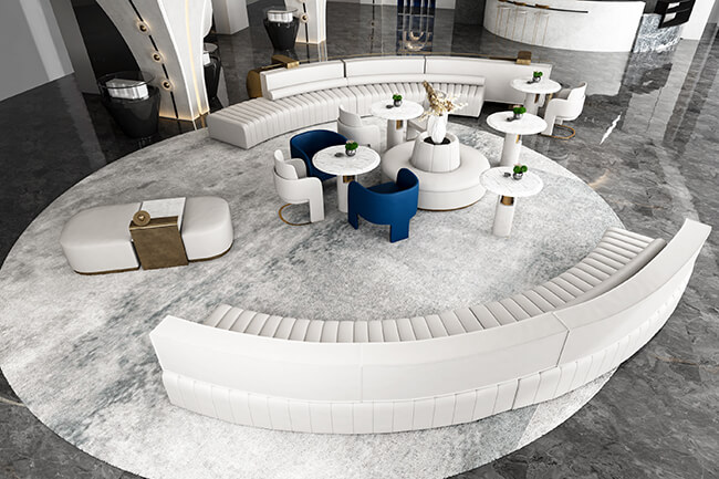 a large circular room with white couches and tables